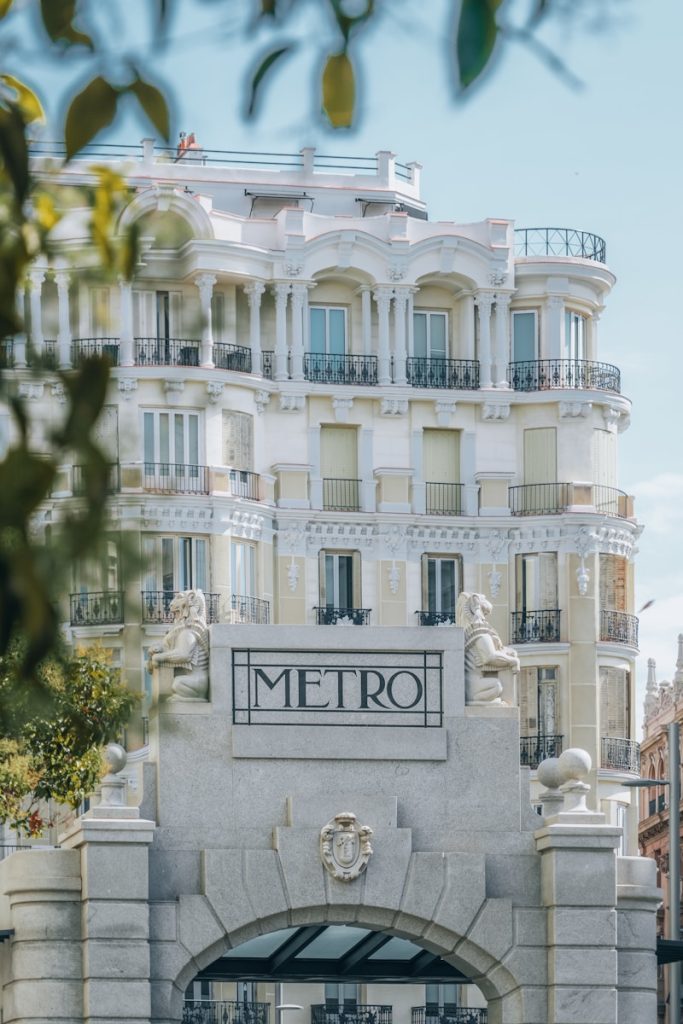 A tall white building sitting next to a street