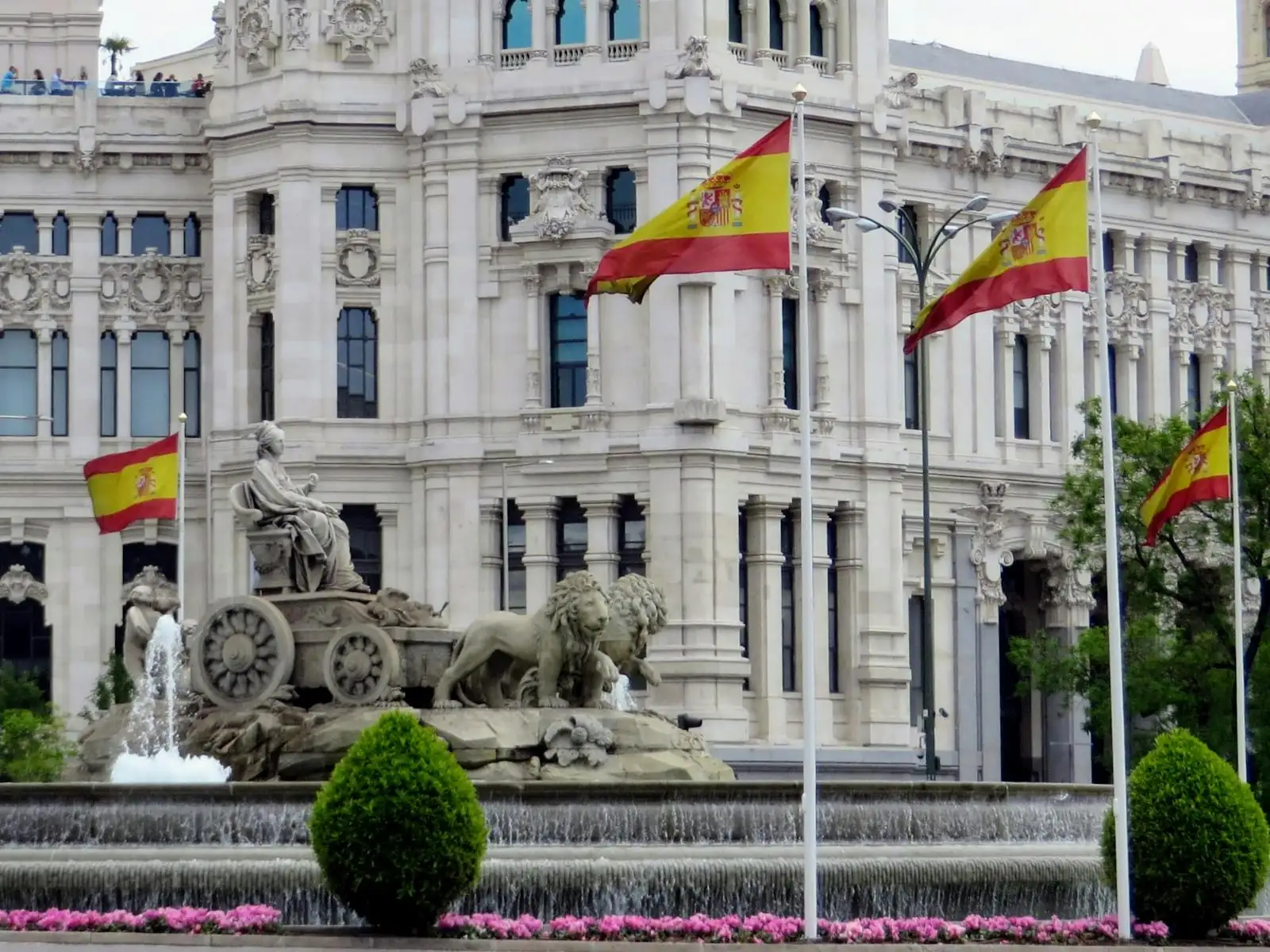 Cibeles Fountain with Spanish flags at the Palace of Communications in Madrid.
